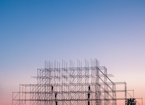 A silhouetted structure against a colorful sunset, showcasing industrial scaffolding in Sochi, Russia.